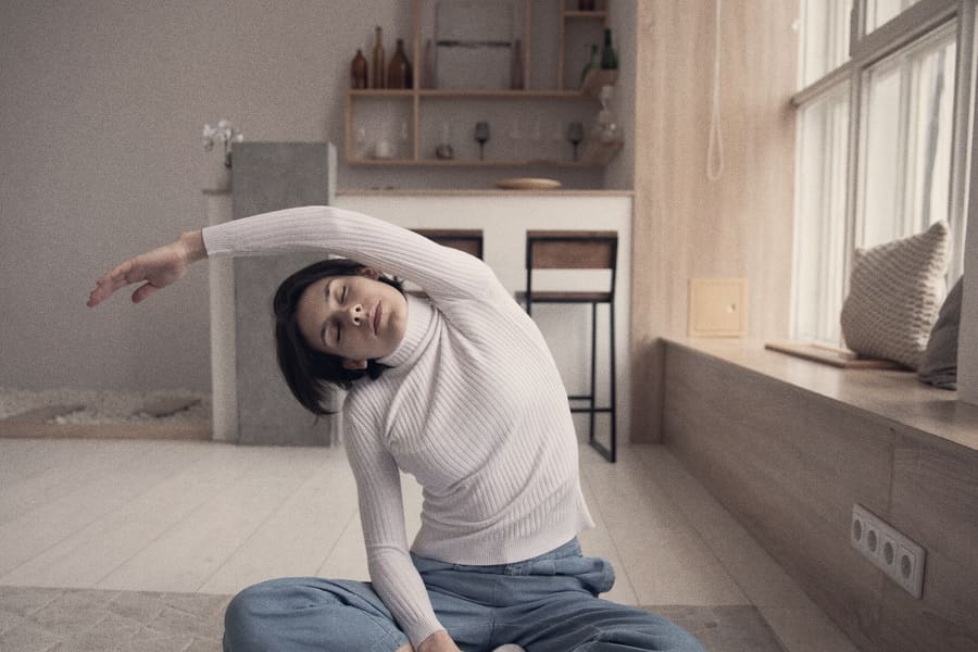 A practitioner in a slow seated side bend, taken at breath's pace