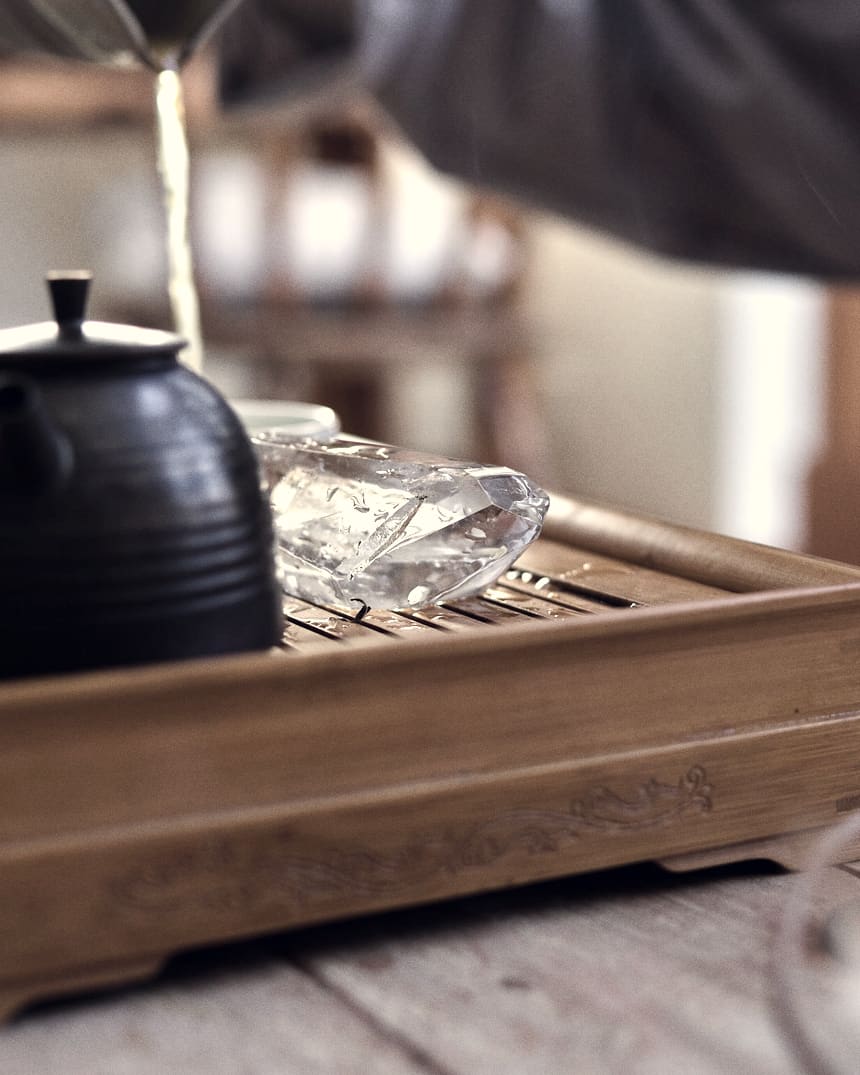 Tea poured into a rustic cup in low, warm afternoon light